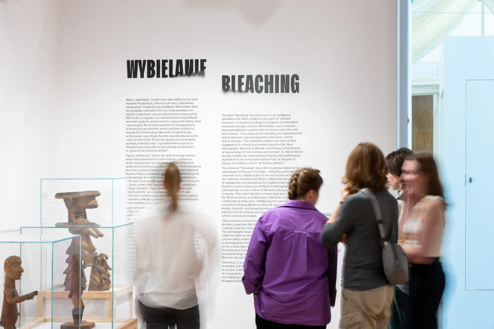 View of the exhibition. Visitors in front of the curator’s text.